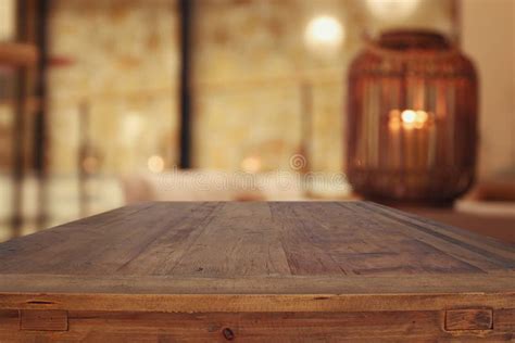 Wooden Table In Front Of Abstract Living Room Background Stock Photo