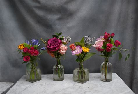 Colorful Mini Bud Vase Arrangement In Small Clear Bottles Roses Spray