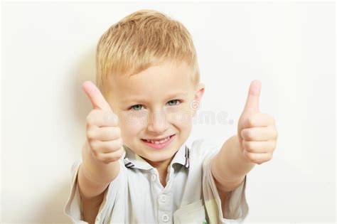 Happy Childhood Smiling Blond Boy Child Kid Showing Thumb Up Stock