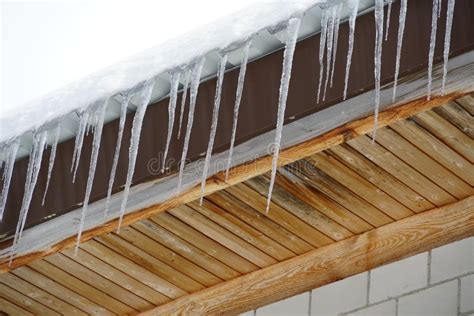 Melting Icicles As Symbol Of Ending Winter And Thaw Hanging From A Roof