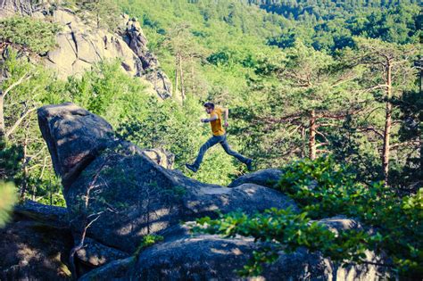 A Man Is Jumping On Top Of A Mountain Stock Photo Image Of Outdoor