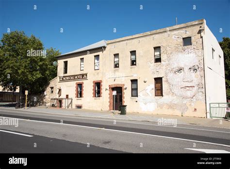 Old Norfolk Hotel Building With Custom Face Mural On Weathered Brick In