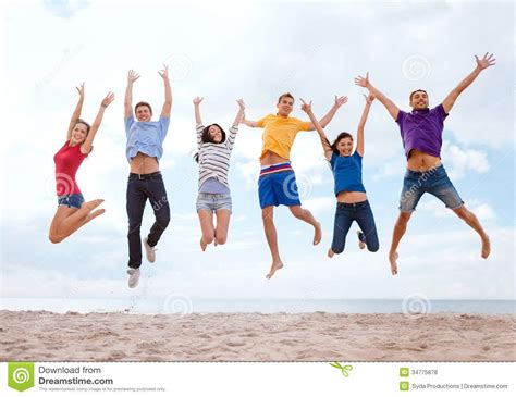 Group Of Friends Jumping On The Beach Stock Photo Image Of Leaping