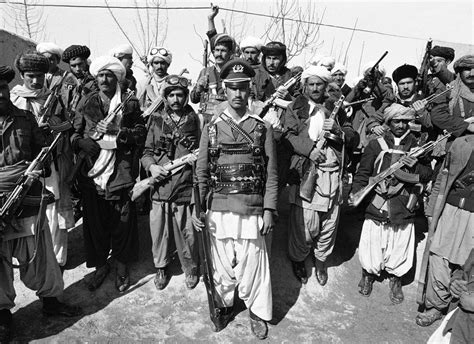 A Mujahideen A Captain In The Afghan Army Before Deserting Poses With A Group Of Rebels Near