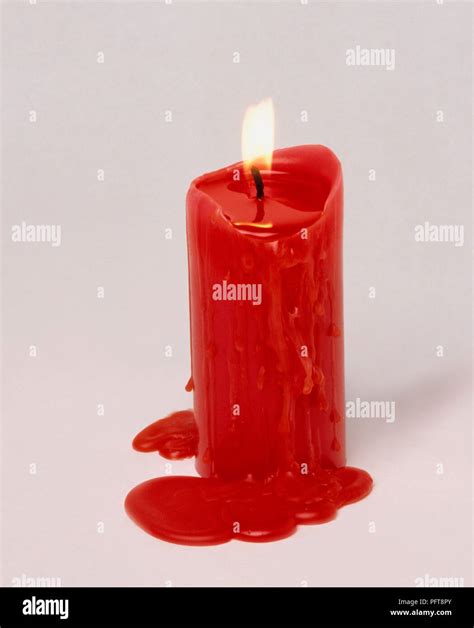 Burning Red Candle With Wax Dripping Down The Sides Stock Photo Alamy