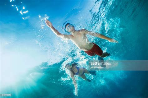 Young Man And Woman Snorkeling Underwater Diving Adventure Turquoise