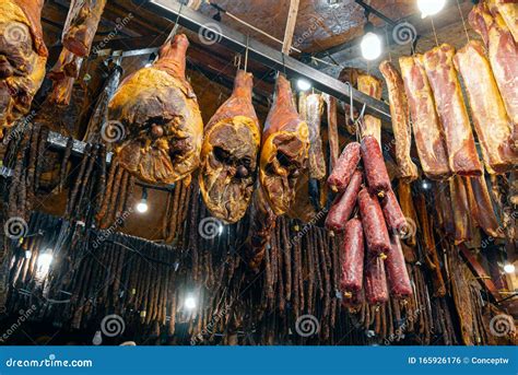 Traditional Smoked Pork Meat Products Hanging In Smokehouse Stock Photo