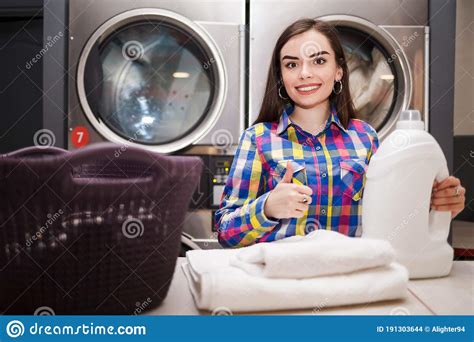Girl Pleased With The Result Of Washing Woman In Laundromat Showing