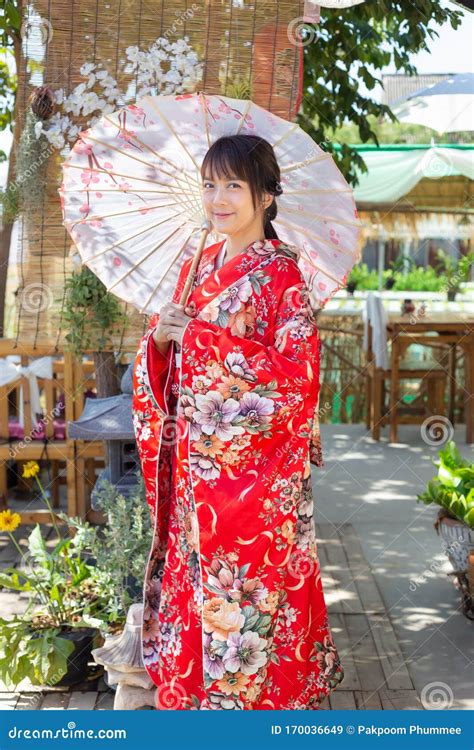 The Girl Is Wearing A Red Traditional Kimono Which Is The National