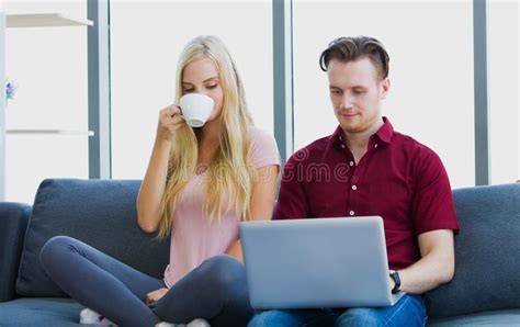 Young Couple Watching Tv On Sofa At Home Stock Photo Image Of Living