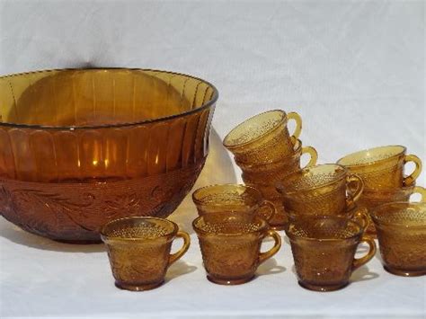 A vintage punch bowl serving set by towle offers silver plate construction with footed bowl having scalloped foliate rim, decorated under plate and twelve set of six etched glass eggnog or punch bowl glasses. huge amber glass punch bowl / cups set, vintage Tiara ...