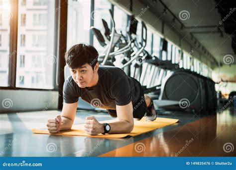 Portrait Of Asian Fitness Man Doing Planking Exercise In Gym People