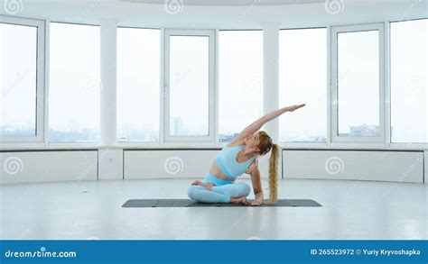 Yogi Woman Practicing Seated Side Bend Pose Or Parsva Sukhasana In Yoga