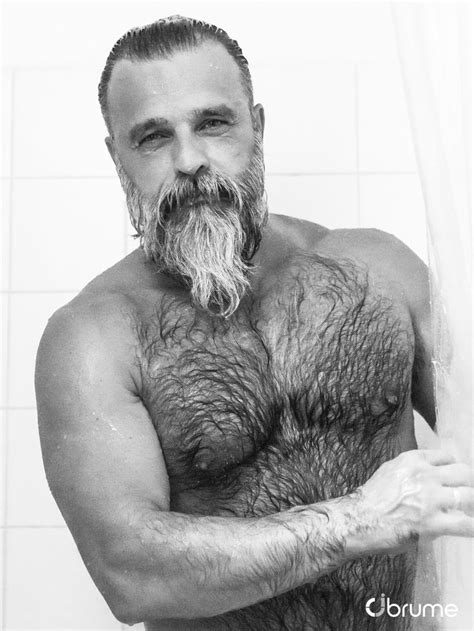A Man With A Beard And No Shirt Is Standing In The Shower Holding His Hands On His Hips