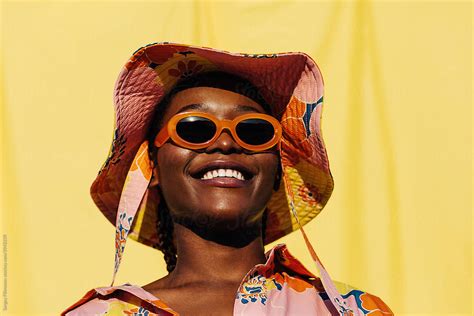 Delighted Black Woman In Sunglasses And Sunhat By Stocksy Contributor