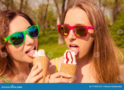 portrait of two girls in glasses licking ice cream stock image image of sisters eyewear
