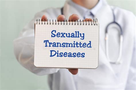 Doctor Writing Word Sexually Transmitted Diseases With Marker Medical