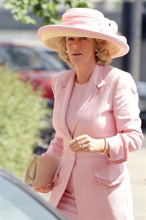 A Woman In A Pink Suit And Hat