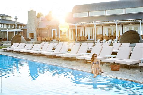 Woman Relaxing By Pool At Luxury Resort At Sunset By Trinette Reed