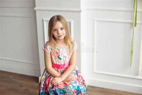 Full Length Of Little Smiling Girl Child In Colorful Dress Posing