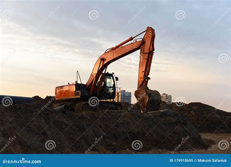 Red Excavator During Groundwork On Construction Site Hydraulic Backhoe