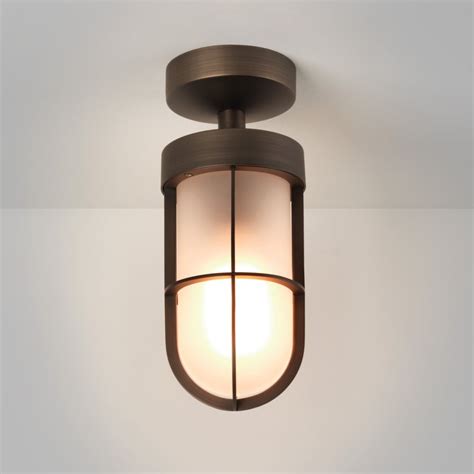 Place this fixture in a living room or pair it up going down a long hallway for a unified look. Astro Lighting 7853 Cabin IP44 Frosted Glass Ceiling Light in Bronze