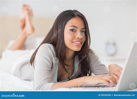 Pretty Girl Lying On Bed Using Her Laptop Smiling At Camera Stock Image Image Of Length Leisu