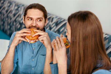 Friends Eating Burgers Indoors Stock Photo Image Of Meal Burgers