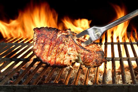 Meat Chop Cooked On The Barbecue Grill Flame Of Fire In The Background Buggy Parks