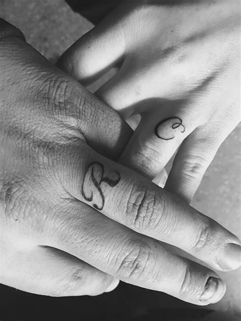 His And Her Initial Tattoo On Ring Finger Couple Ring Finger Tattoos Tattoo Wedding Rings