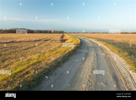 A Curve Shaped Dirt Road Through Meadows Sunny Day Stock Photo Alamy