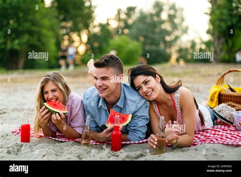 Group Of Young Friends Having Fun At The Beach On Vacation Party People Happiness Concept Stock
