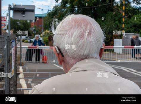 Rear View Of Old Man Waiting For Train Crossing Hi Res Stock