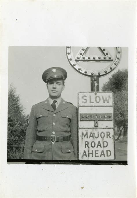 Uniformed Serviceman Stands In Front Of Sign The Digital Collections