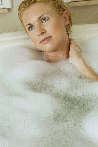 Mid Adult Woman Unwinding In Bubble Bath Portrait Stock Photo Dissolve