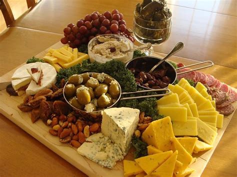 A Lovely Layout With A Selection Of Cheeses Olives Fruit And Nuts