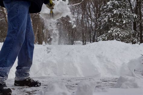 Close Up View Of An Unidentifiable Person Shoveling Deep Snow Stock