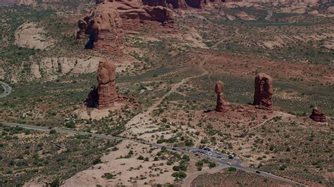 5 5k stock footage aerial video of closely circling balanced rock and arches scenic drive
