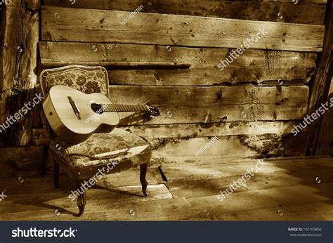 Blues Guitar On A Old Chair With Wooden Background