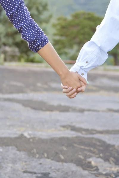 Happy Couple Holding Hands Stock Photo By ©alexshalamov 56640889
