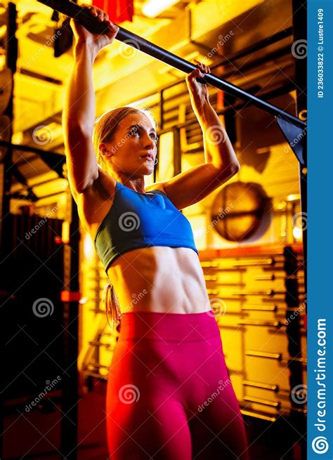Cropped Portrait Of Young Sportive Girl Training In The Gym Doing Pull