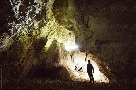 Cave Entrance With Man Silhouette Del Colaborador De Stocksy Cosma