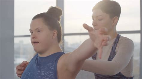 Cheerful Young Disabled Woman With Down Syndrome Doing Yoga Exercise