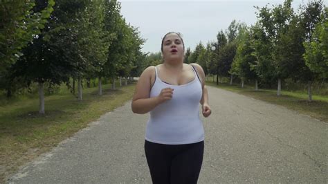 Fat Girl Runs Along The Road Stock Video Footage 0012 Sbv 327480016