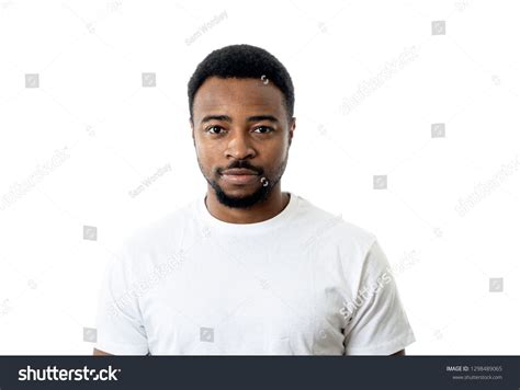 Portrait Of Attractive Confident African American Young Man Looking Neutral Relaxed And Serious