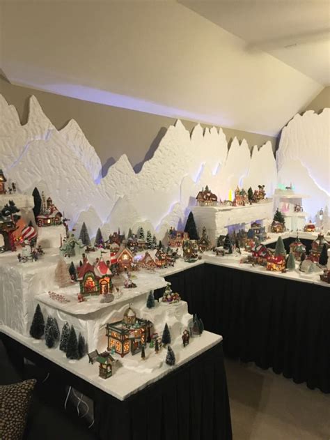 A Room Filled With Lots Of Fake Snow And Christmas Decorations On Top