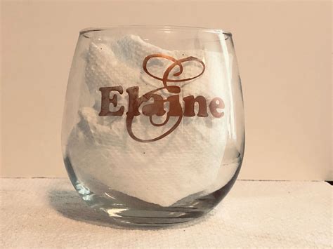 A Glass Filled With White Powder Sitting On Top Of A Table Next To A Wall