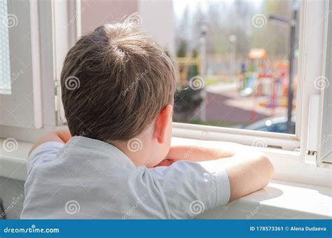 Cute Sad Boy Of Four Years Old Is Sitting On The Balcony And Looking