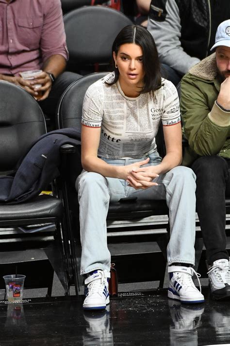 Kendall Jenner Wears A John Galliano Newspaper Print Tee To A Los Angeles Clippers Game Vogue