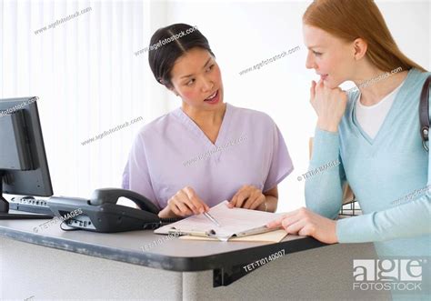Nurse Talking To Patient In Doctors Office Stock Photo Picture And